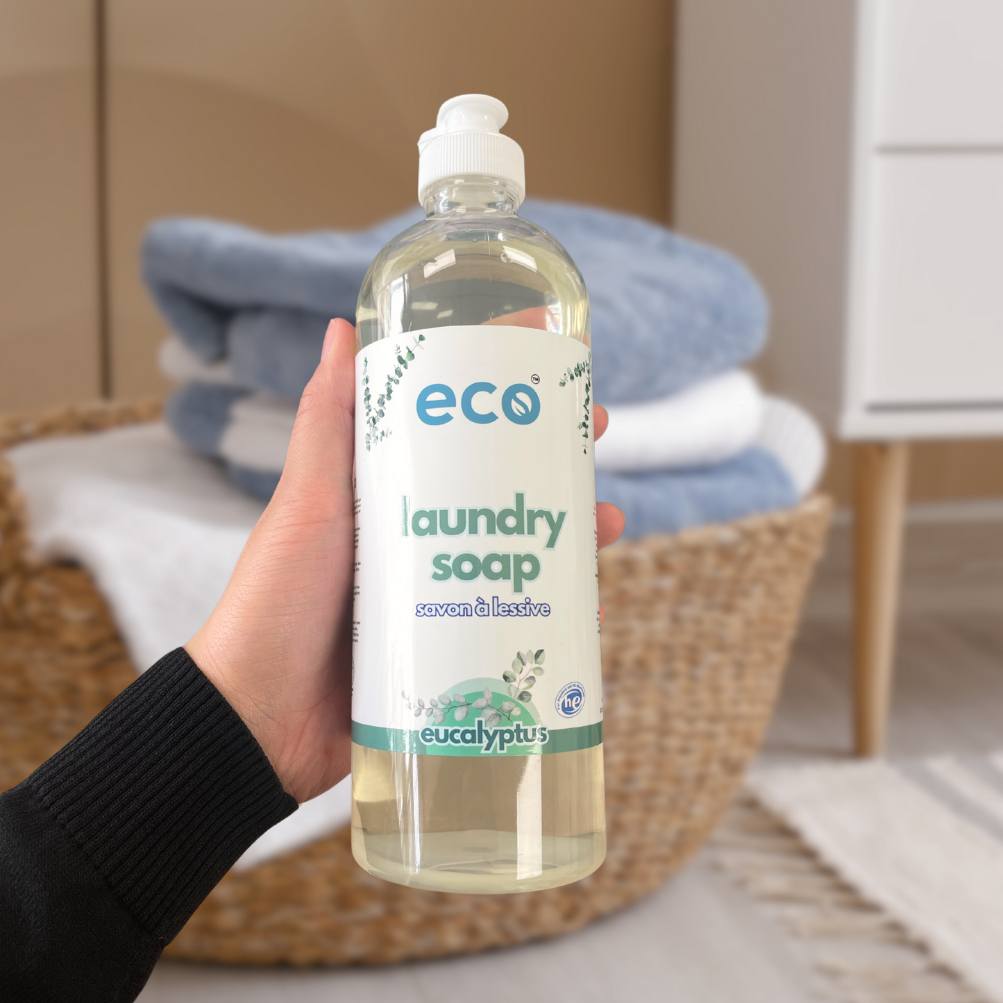 Person holding Eco Refillery's laundry soap, for an eco-friendly and plant-based home.