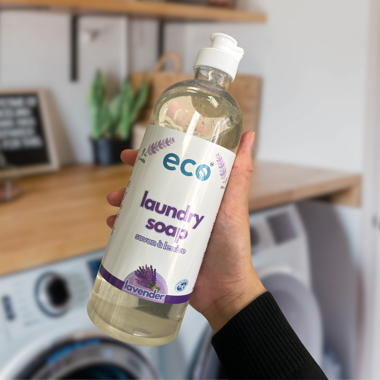 Person holding Eco Refillery's laundry soap, for an eco-friendly and plant-based laundry routine.